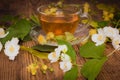 Cup of tea linden jasmine on wooden background