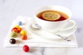 Cup of tea and multicolored chocolate drops Royalty Free Stock Photo