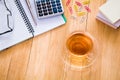 Cup of tea, notebook with pen, calculator and glasses on the desktop. Business concept Royalty Free Stock Photo