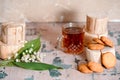 a Cup of tea, nuts, bouquet of lilacs on a wooden table Royalty Free Stock Photo