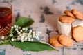 a Cup of tea, nuts, bouquet of lilacs on a wooden table Royalty Free Stock Photo