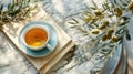 A cup of tea and an olive branch rest peacefully on a luxurious marble table, creating a serene and elegant still life