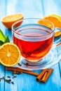 A cup of tea with orange slices and cinnamon sticks Royalty Free Stock Photo