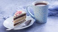 A cup of tea and a piece of tasty creamy cake