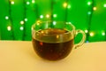 Cup of tea on a plaid and garland background