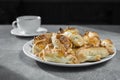 A cup of tea with a plate of croissants on the kitchen table. dessert side view. morning coffee with sweets. recipe of dish