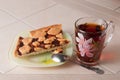 Cup of tea and plum cake with crumb on parchment paper