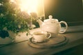 Cup, tea pot ,cookies and laptop on wooden desk Royalty Free Stock Photo