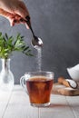 In a cup of tea, pour a sugar substitute from a teaspoon. Stevia, erythritol.