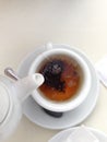 Cup of tea, reflection of sky and trees inside the cup, on white table. Royalty Free Stock Photo