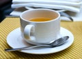 Cup of tea on saucer with a spoon