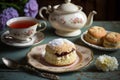 A cup of tea with scones and jam and cream.