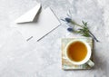 Cup of Tea and Sea Holly Flowers on gray stone background Royalty Free Stock Photo