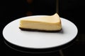 Cup of tea and slice of cheesecake on white plate on table Royalty Free Stock Photo