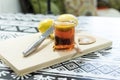 Cup of tea with a slice of lemon on a cutting board with lemons, a knife and sugar Royalty Free Stock Photo