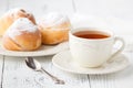 Cup of tea and small apple roses shaped pies. Sweet apple dessert pie