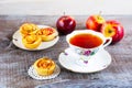 Cup of tea and small apple roses shaped pies Royalty Free Stock Photo