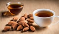 A cup of tea and a small bowl of almonds