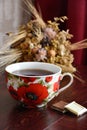 Cup of tea with sweets and dry flowers on the table. Royalty Free Stock Photo
