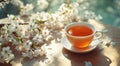 cup of tea on table with some cherry blossoms