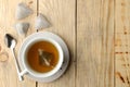 Cup with tea and tea bag pyramid. close-up. on a wooden table. to make tea Royalty Free Stock Photo