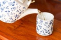 A cup of tea with teapot in the background Royalty Free Stock Photo