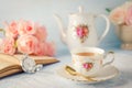 Cup of tea with teapot and flowers with vintage tone Royalty Free Stock Photo