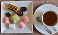 A cup of tea and various sweets Royalty Free Stock Photo