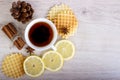 Cup of tea with waffles and cinnamon, lemon, badian, pinecone Royalty Free Stock Photo