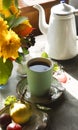 A cup of tea, white teapot and a bouquet of autumn flowers, early autumn morning concept Royalty Free Stock Photo