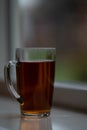 Cup of tea on windowsill in blurred background