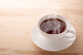 Cup of tea on wooden background. Warm tea cup on light wooden table. Copy space. Top view