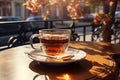 Cup of tea on the wooden table in cafe. warm morning dawn sun light