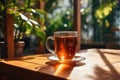 Cup of tea on the wooden table in cafe. warm morning dawn sun light