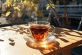 Cup of tea on the wooden table in cafe. warm morning dawn sun light