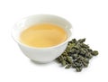 Cup of Tie Guan Yin oolong and tea leaves on white Royalty Free Stock Photo