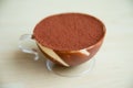 Cup of Tiramisu cake on wood pattern background