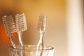 Cup with toothbrushes on blurred background.