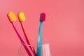 Cup with toothbrushes on table against color background. Royalty Free Stock Photo