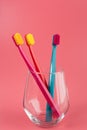 Cup with toothbrushes on table against color background. Royalty Free Stock Photo