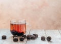 A cup of traditional Chinese puer tea with aged puerh tea bricks