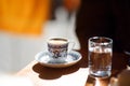 Cup of traditional turkish coffee and glass of water on a wooden table of street cafe on sunny spring day in Istanbul, Turkey Royalty Free Stock Photo