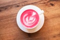 Cup of trendy beetroot latte on table. Royalty Free Stock Photo