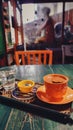 A cup of Turkish coffee served on a tray on a green wooden table, a glass of water and Turkish delight in a small ceramic plate Royalty Free Stock Photo