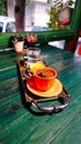 A cup of Turkish coffee served on a tray on a green wooden table, a glass of water and Turkish delight in a small ceramic plate Royalty Free Stock Photo