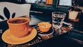 A cup of Turkish coffee served on a tray on a green wooden table, a glass of water and Turkish delight in a small ceramic plate Royalty Free Stock Photo