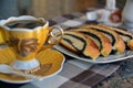 Cup of Turkish coffee and slices of poppy seeds strudel rolls