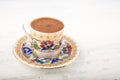 A cup of Turkish coffee on a wooden background