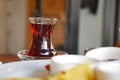 Cup of turkish tea on a table with snacks nearby in a cafe setting Royalty Free Stock Photo