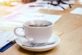 Cup of white coffee with smoke. folders and documents on desk with glasses and laptop on wood Royalty Free Stock Photo